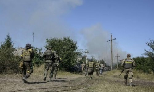 Ukraine leader says Russian forces are in the country as key town falls