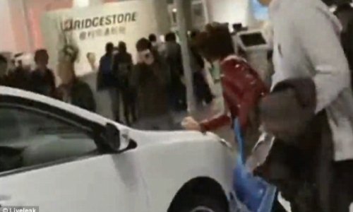 Woman scratches luxury car at motor show to force husband into buying it - VIDEO