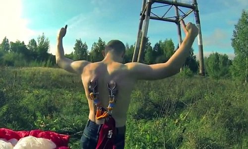 Extreme bungee jumpers attach metal hooks on harness to their skin - PHOTO