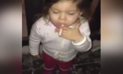 Frightening footage of toddler girl puffing on a cigarette - VIDEO