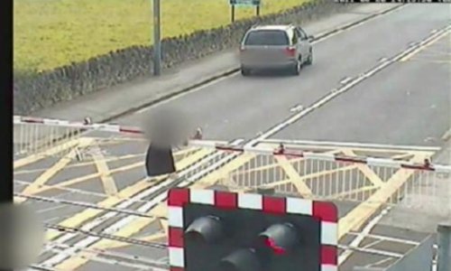 Moment a pensioner is hit by a train on a level crossing - VIDEO