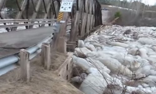 Bridge shifting up to six feet by river of ice boulders - VIDEO