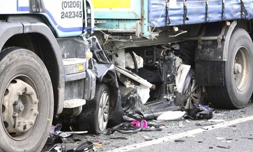 VW Golf completely crushed under articulated lorry