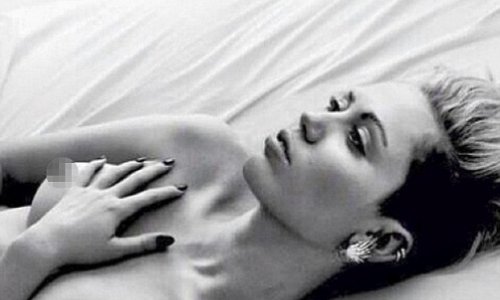 Miley Cyrus goes topless in sultry bedroom