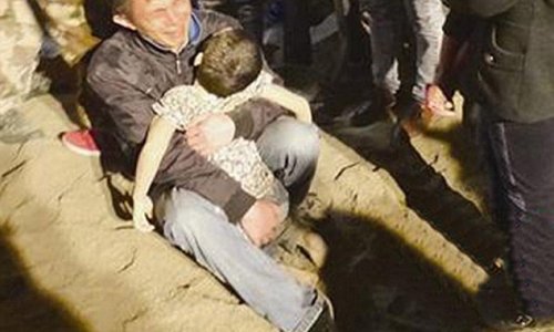 Father cradles his six-year-old son after he was buried alive by lorry