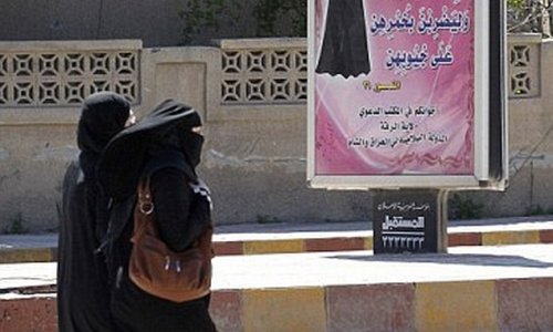 ISIS morality police arrest a woman wearing full burkha and face veil