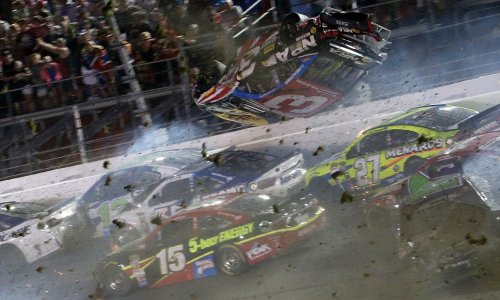 NASCAR driver flips over racetrack before smashing into fence at 200mph