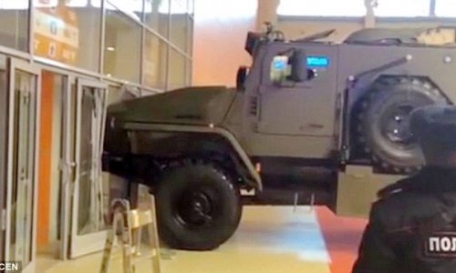 Woman attempts to drive off in an armoured personnel carrier
