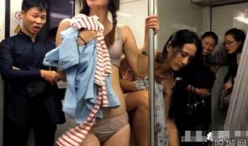 Women undress themselves on subway to promote business - VIDEO