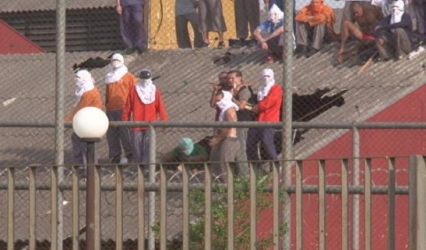 Masked prison rioters 'set hostages on fire and throw them from roof of jail' Masked prison rioters 'set hostages on fire and throw them from roof of jail'