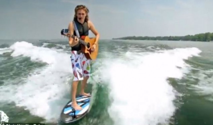 Musician who can play his guitar while riding his surfboard Musician who can play his guitar while riding his surfboard