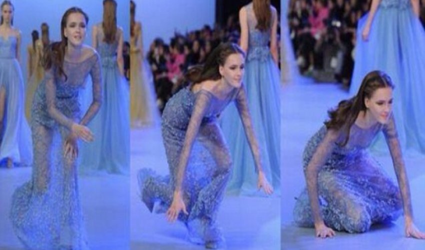 Model takes a tumble as she sashays down the catwalk - VIDEO