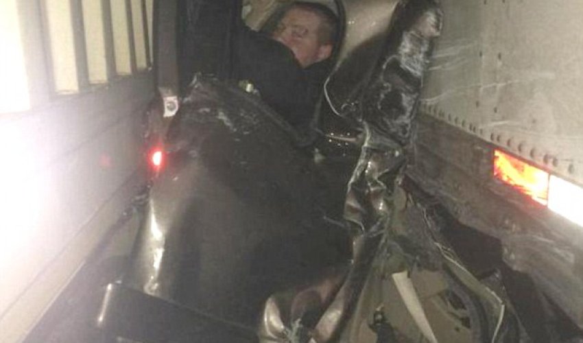 Pictured in mangled wreckage that saved his life