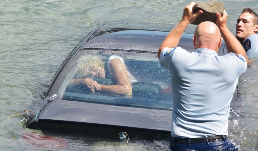 Police smashed their way into a woman's sinking BMW Police smashed their way into a woman's sinking BMW