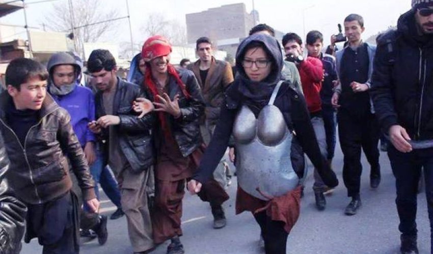 Woman in armour protesting against sexual harassment pelted with rocks