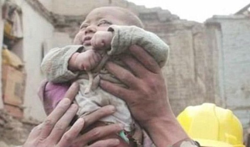 Incredible moment four-month-old baby is pulled ALIVE from the rubble