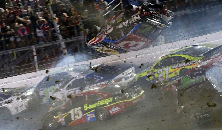 NASCAR driver flips over racetrack before smashing into fence at 200mph NASCAR driver flips over racetrack before smashing into fence at 200mph