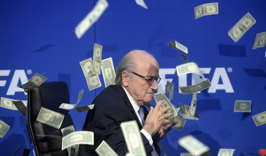 Shamed FIFA president Sepp Blatter is showered in fake dollar bills Shamed FIFA president Sepp Blatter is showered in fake dollar bills