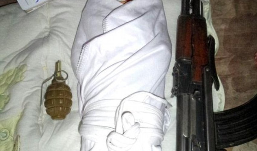 Baby jihadis: Tiny child pictured next to a gun is the face of a new wave of ISIS recruitment