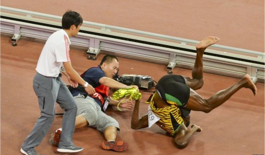 Usain Bolt knocked down in Beijing - in pictures