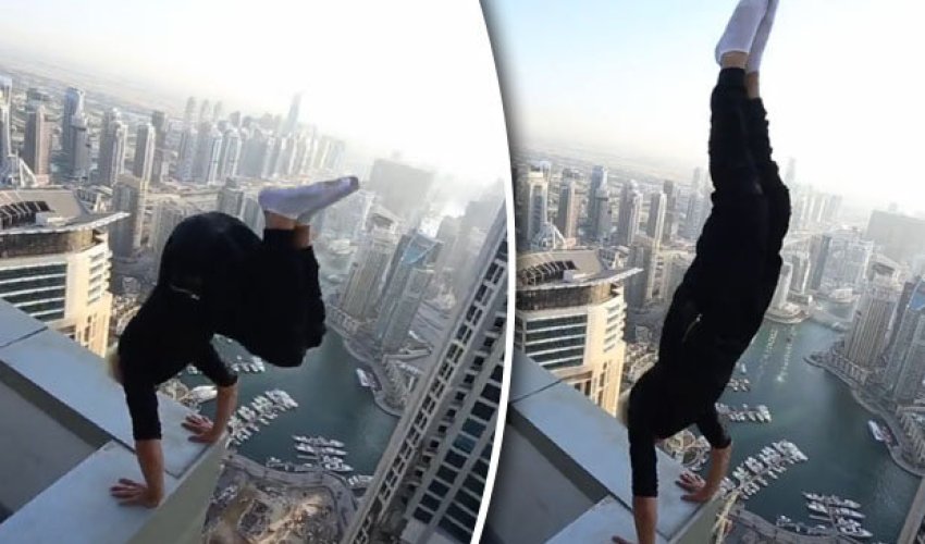 Man risks death performing handstand on skyscraper roof ledge Man risks death performing handstand on skyscraper roof ledge