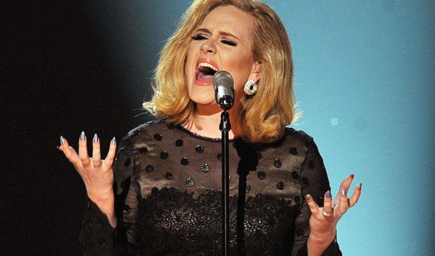 Adele big winner at BRIT Awards as industry pays tearful tribute to Bowie