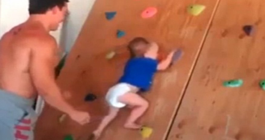 20-month-old baby scales wall at indoor gym with no ropes - VIDEO