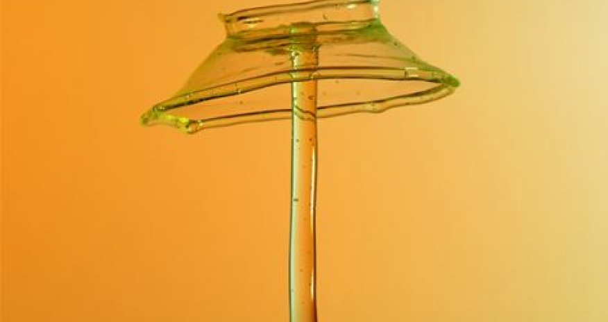 Artist drops paint onto liquid mixture and quickly captures point of impact - PHOTO