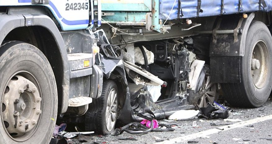 VW Golf completely crushed under articulated lorry