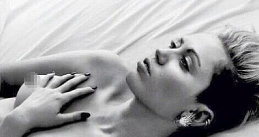 Miley Cyrus goes topless in sultry bedroom