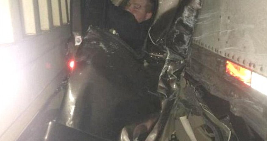 Pictured in mangled wreckage that saved his life