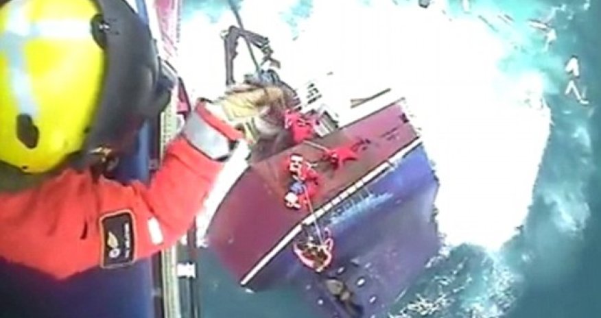 Dramatic footage shows moment fishermen cling