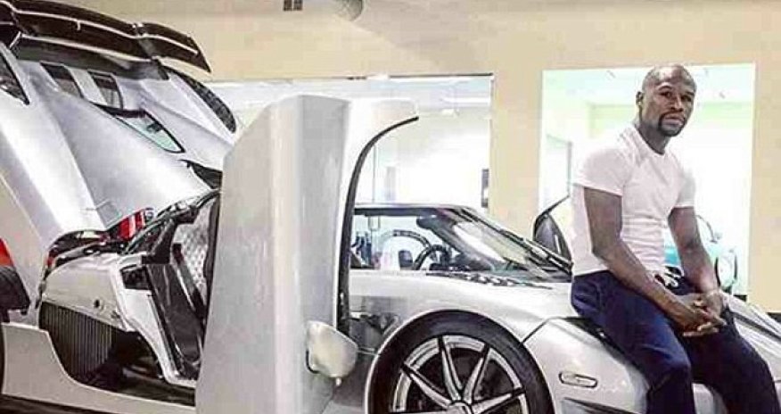 Floyd Mayweather poses for photo on top of £3m Koenigsegg supercar