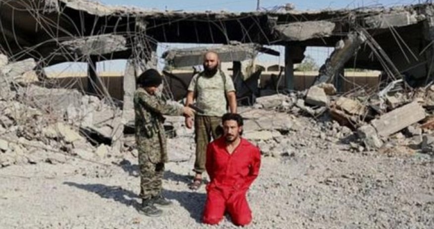 ISIS prisoner is 'executed by a child who shoots handcuffed man in the head'