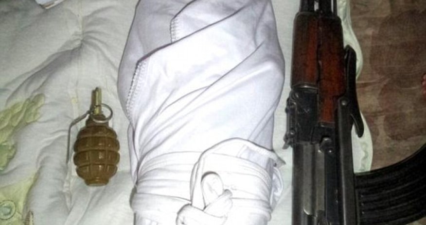 Baby jihadis: Tiny child pictured next to a gun is the face of a new wave of ISIS recruitment
