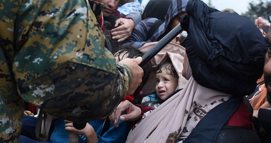 Thousands of migrants battle with riot police