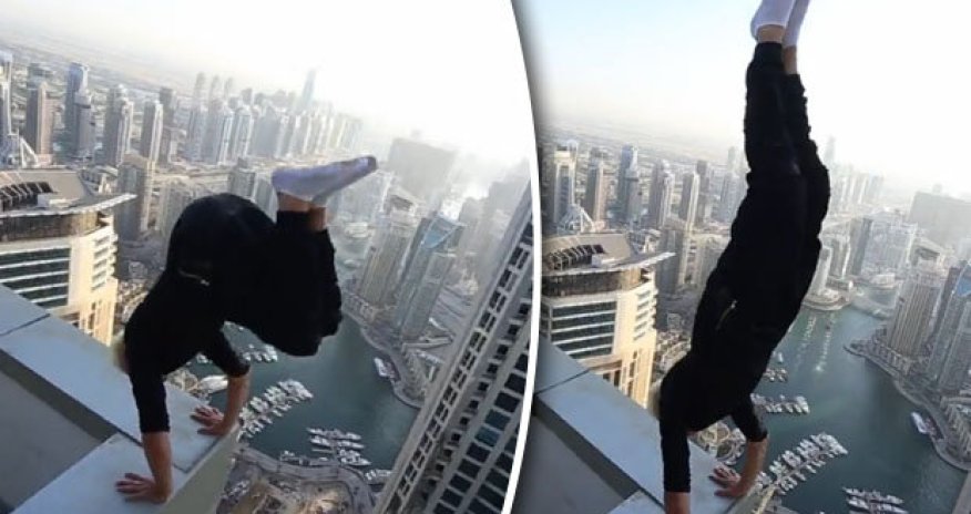 Man risks death performing handstand on skyscraper roof ledge