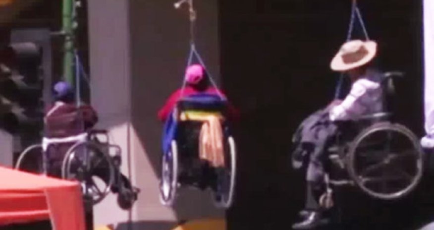Wheelchair users dangle from bridge in extreme anti government protest